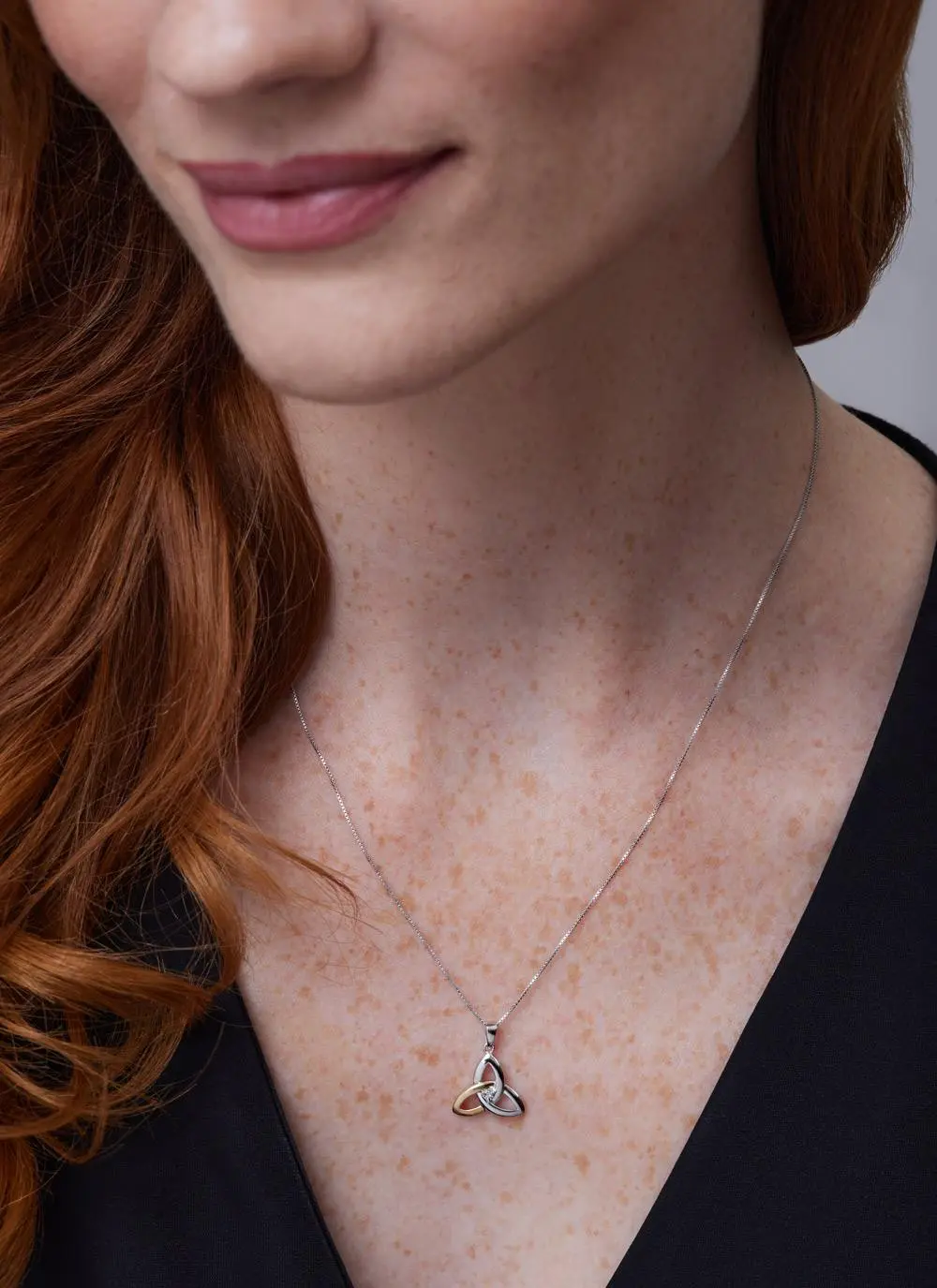 Close up shot of red haired model wearing 10ct Gold 